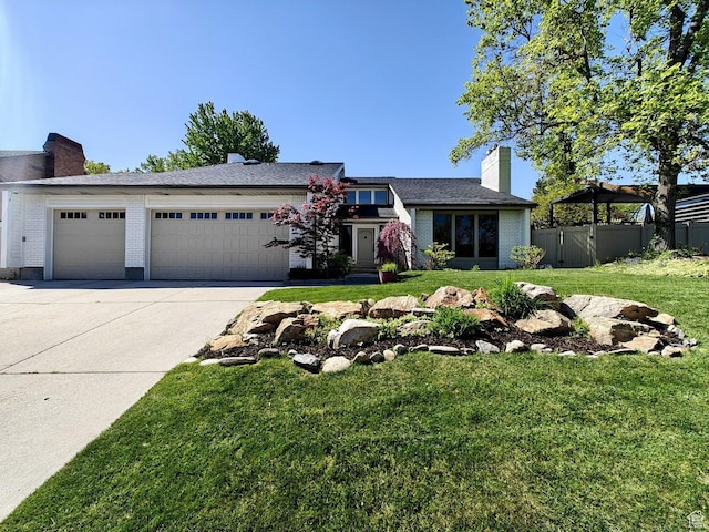 view of front of property with driveway, a chimney, a garage, fence, and a front lawn