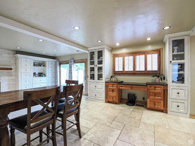 418 E Bridlewalk Ln, Murray, UT 84107 - kitchen featuring glass insert cabinets, brown cabinets, recessed lighting, and stone tile floors