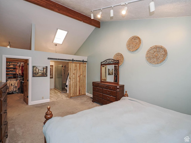 418 E Bridlewalk Ln, Murray, UT 84107 - carpeted bedroom featuring baseboards, a barn door, lofted ceiling with beams, and a walk in closet