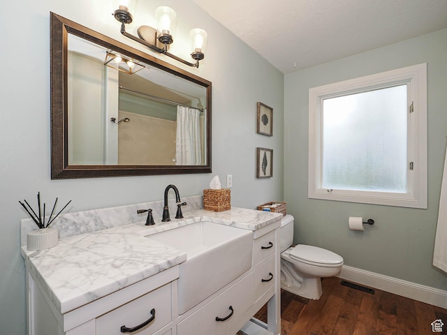418 E Bridlewalk Ln, Murray, UT 84107 - bathroom featuring visible vents, wood finished floors, baseboards, vanity, and toilet