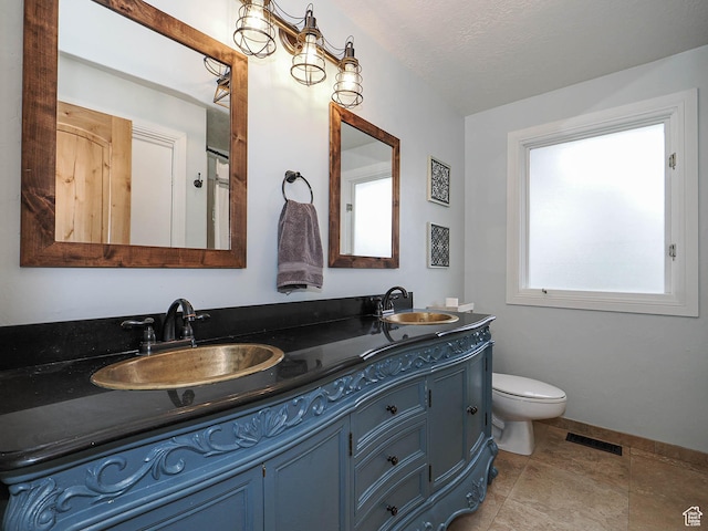 418 E Bridlewalk Ln, Murray, UT 84107 - bathroom featuring double vanity, toilet, visible vents, and a sink