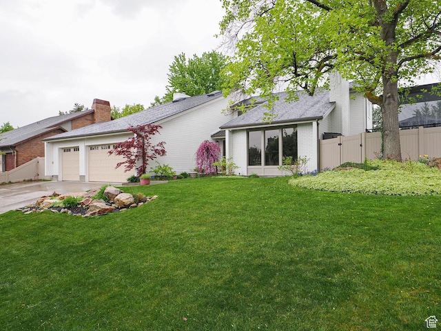418 E Bridlewalk Ln, Murray, UT 84107 - view of front facade with a front lawn, fence, brick siding, concrete driveway, and an attached garage