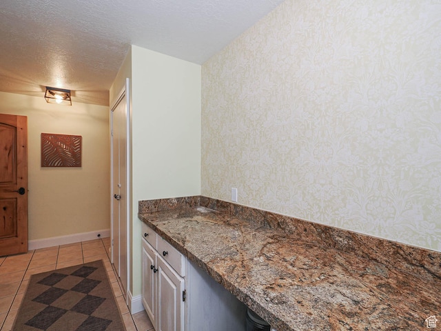 418 E Bridlewalk Ln, Murray, UT 84107 - bathroom with baseboards, a textured ceiling, tile patterned floors, and wallpapered walls