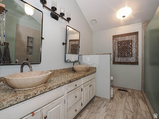 418 E Bridlewalk Ln, Murray, UT 84107 - full bath with visible vents, a sink, vaulted ceiling, and double vanity