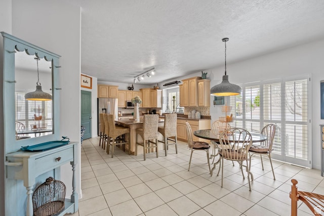 6272 S Lake Fork Cir, Taylorsville, UT 84129 - dining area featuring track lighting, a textured ceiling, and light tile patterned flooring