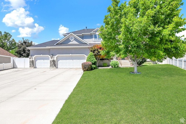 6272 S Lake Fork Cir, Taylorsville, UT 84129 - view of front of house featuring a garage, a front lawn, fence, stucco siding, and driveway