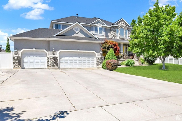 6272 S Lake Fork Cir, Taylorsville, UT 84129 - view of front of house featuring a front yard, stone siding, stucco siding, an attached garage, and driveway