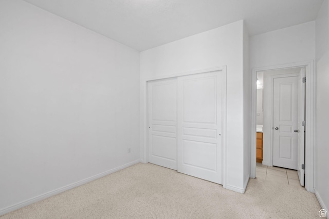 6272 S Lake Fork Cir, Taylorsville, UT 84129 - unfurnished bedroom with baseboards, light carpet, and a closet