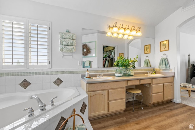 6272 S Lake Fork Cir, Taylorsville, UT 84129 - bathroom with double vanity, a sink, a bath, and wood finished floors