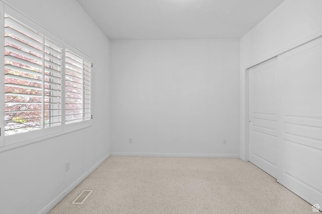 6272 S Lake Fork Cir, Taylorsville, UT 84129 - unfurnished bedroom featuring visible vents, carpet flooring, and multiple windows