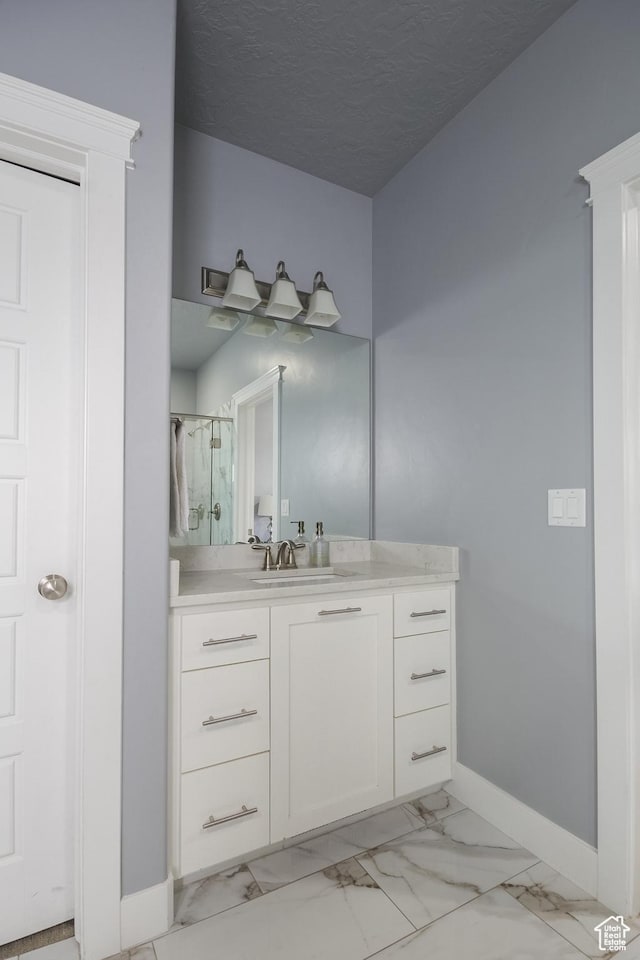 1428 N 4075 W, Vernal, UT 84078 - bathroom with vanity, baseboards, a shower stall, and marble finish floor
