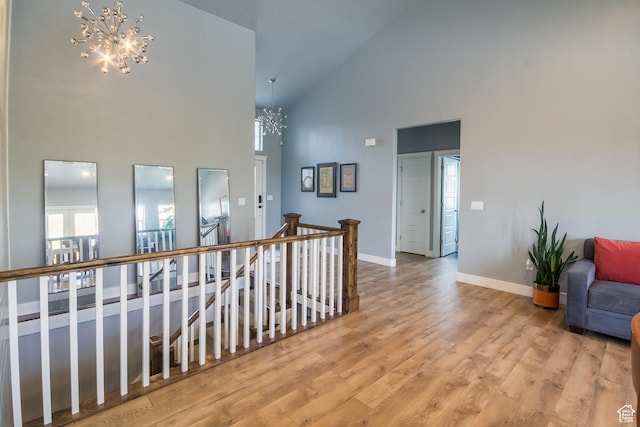 1428 N 4075 W, Vernal, UT 84078 - hallway with wood finished floors, high vaulted ceiling, baseboards, an upstairs landing, and an inviting chandelier