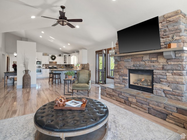 3540 N Elkview Dr, Eden, UT 84310 - living room with a fireplace, ceiling fan, vaulted ceiling, and light wood-type flooring
