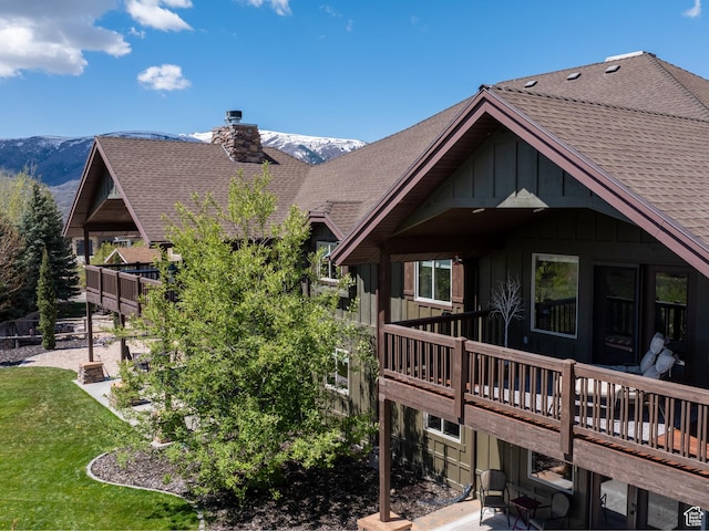 3540 N Elkview Dr, Eden, UT 84310 - back of house with roof with shingles, board and batten siding, a chimney, and a deck with mountain view