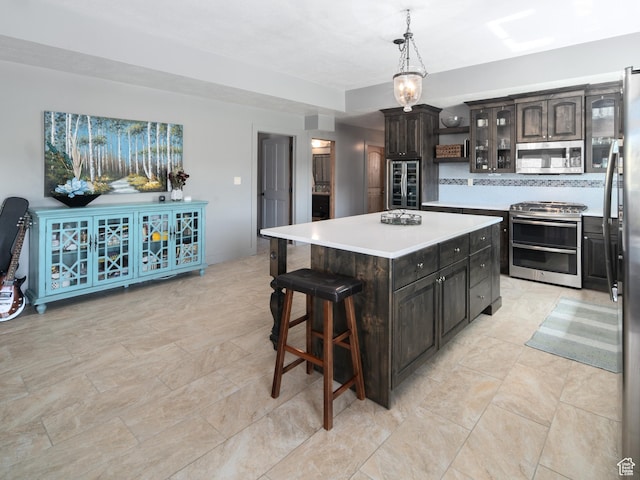 3540 N Elkview Dr, Eden, UT 84310 - kitchen featuring a kitchen island, tasteful backsplash, light countertops, glass insert cabinets, and stainless steel appliances