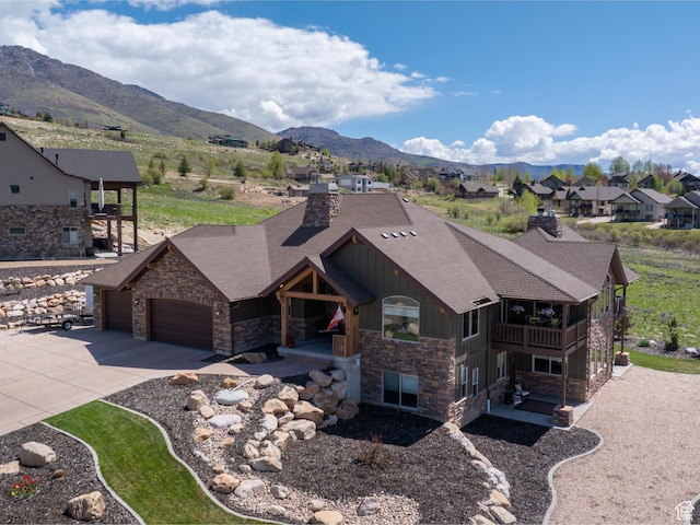 3540 N Elkview Dr, Eden, UT 84310 - view of front facade featuring an attached garage, stone siding, board and batten siding, a chimney, and a balcony