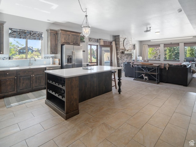 3540 N Elkview Dr, Eden, UT 84310 - kitchen with light countertops, open floor plan, stainless steel fridge, and dark brown cabinetry