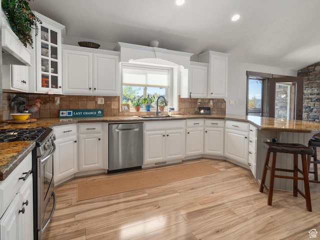 3540 N Elkview Dr, Eden, UT 84310 - kitchen featuring light wood-type flooring, a sink, a peninsula, stainless steel appliances, and white cabinetry