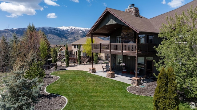 3540 N Elkview Dr, Eden, UT 84310 - rear view of property with board and batten siding, a patio area, a yard, and a deck with mountain view