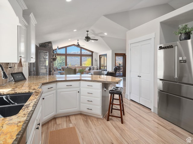 3540 N Elkview Dr, Eden, UT 84310 - kitchen featuring ceiling fan, high end refrigerator, a peninsula, lofted ceiling, and white cabinetry