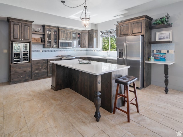 3540 N Elkview Dr, Eden, UT 84310 - kitchen featuring light countertops, backsplash, stainless steel appliances, and dark brown cabinets