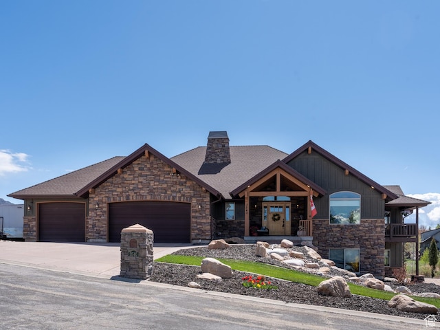 3540 N Elkview Dr, Eden, UT 84310 - view of front of home featuring roof with shingles, driveway, stone siding, and a garage