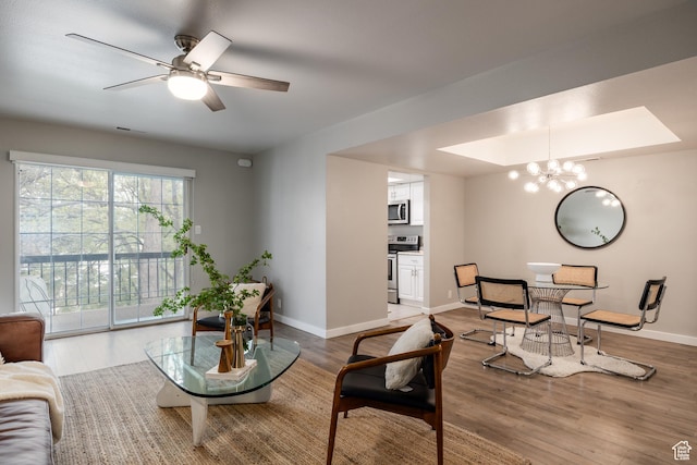 636 E 3990 S Unit D, Millcreek, UT 84107 - living room with baseboards, ceiling fan with notable chandelier, wood finished floors, and visible vents