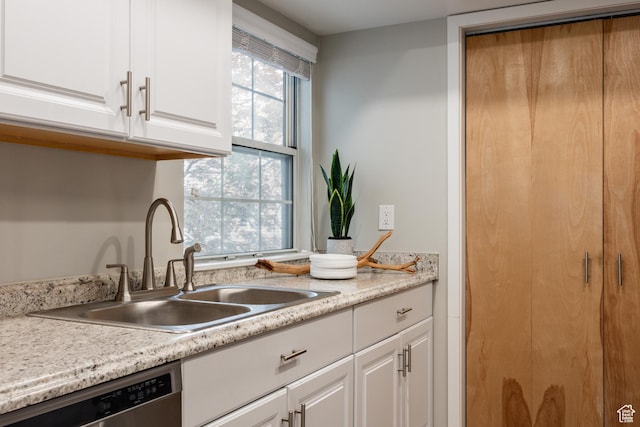 636 E 3990 S Unit D, Millcreek, UT 84107 - kitchen featuring stainless steel dishwasher, a sink, white cabinetry, and light countertops