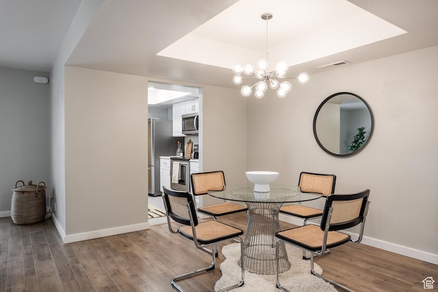 636 E 3990 S Unit D, Millcreek, UT 84107 - dining room with baseboards, light wood finished floors, a notable chandelier, and a tray ceiling