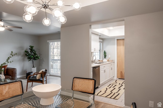 636 E 3990 S Unit D, Millcreek, UT 84107 - interior space featuring baseboards, ceiling fan with notable chandelier, and light wood-style floors