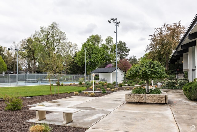 636 E 3990 S Unit D, Millcreek, UT 84107 - view of community featuring fence, an outdoor structure, a yard, a patio, and a tennis court