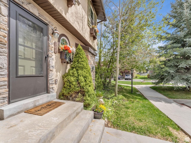 181 Geneva Dr, Midway, UT 84049 - doorway to property featuring a lawn, stucco siding, and stone siding