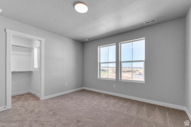 6589 W Bannon St, West Jordan, UT 84081 - unfurnished bedroom featuring a textured ceiling, baseboards, visible vents, and carpet