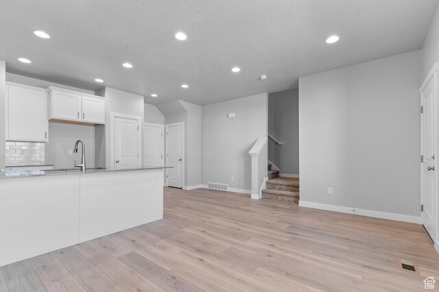 6589 W Bannon St, West Jordan, UT 84081 - unfurnished living room with a sink, recessed lighting, and visible vents