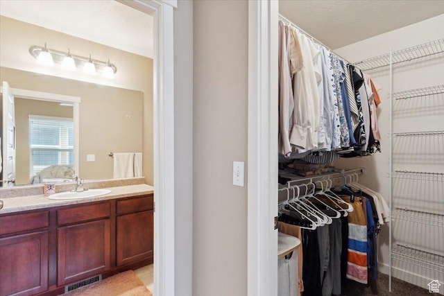 1026 N Shepard Pkwy Unit 3, Farmington, UT 84025 - ensuite bathroom with ensuite bath, vanity, visible vents, and a walk in closet