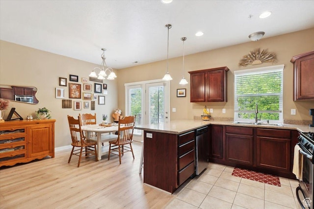 1026 N Shepard Pkwy Unit 3, Farmington, UT 84025 - kitchen with a peninsula, hanging light fixtures, a sink, dishwasher, and gas stove