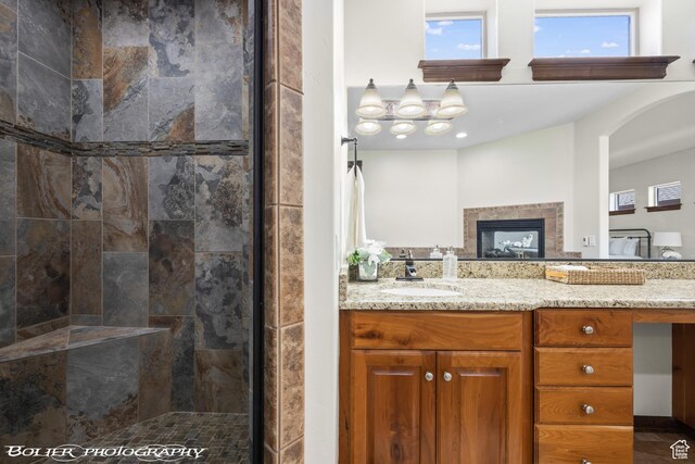 1328 N Parkside Dr, Cedar City, UT 84721 - full bathroom featuring vanity, a fireplace, and a tile shower