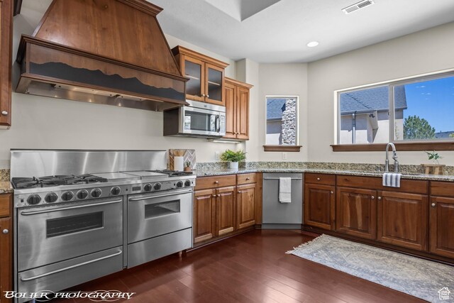 1328 N Parkside Dr, Cedar City, UT 84721 - kitchen with light stone countertops, appliances with stainless steel finishes, dark wood finished floors, and premium range hood