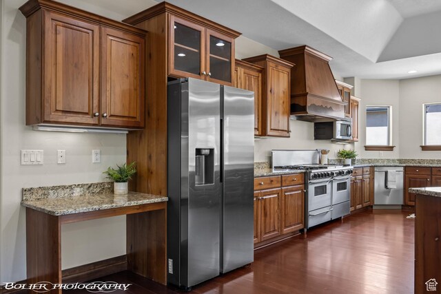 1328 N Parkside Dr, Cedar City, UT 84721 - kitchen with appliances with stainless steel finishes, brown cabinetry, custom range hood, and dark wood-type flooring