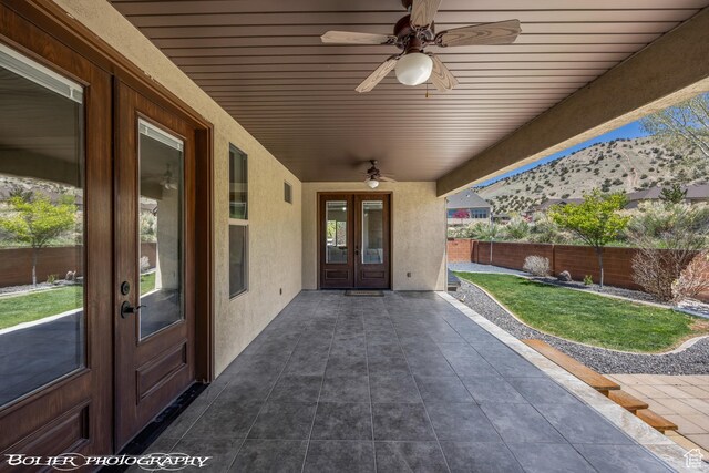 1328 N Parkside Dr, Cedar City, UT 84721 - view of patio featuring ceiling fan, a mountain view, french doors, and fence