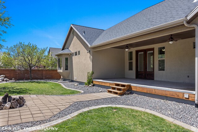 1328 N Parkside Dr, Cedar City, UT 84721 - back of house featuring ceiling fan, french doors, a lawn, fence, and stucco siding