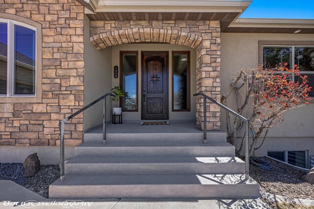 1328 N Parkside Dr, Cedar City, UT 84721 - property entrance with visible vents, stone siding, and stucco siding