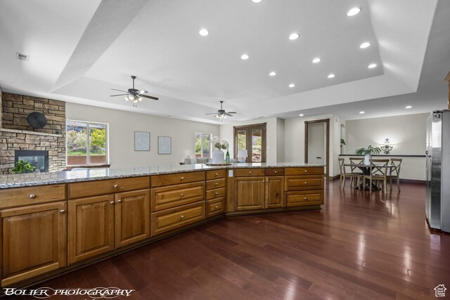 1328 N Parkside Dr, Cedar City, UT 84721 - kitchen with freestanding refrigerator, dark wood-style flooring, a tray ceiling, and brown cabinetry