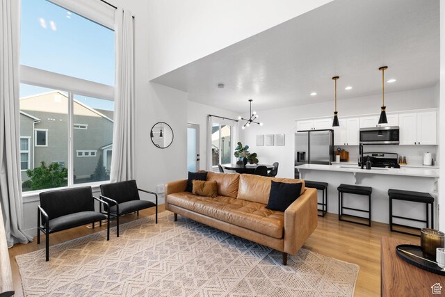 13077 S Keegan Dr, Herriman, UT 84096 - living area with recessed lighting, light wood finished floors, and a chandelier