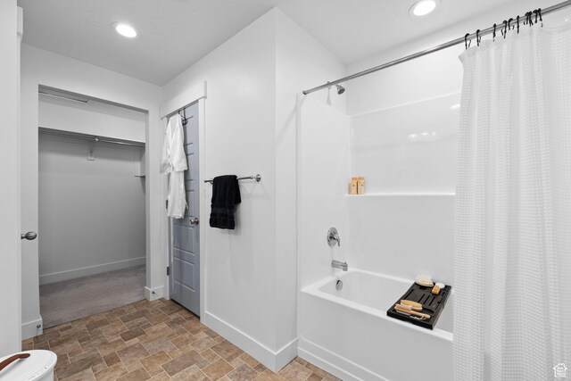 13077 S Keegan Dr, Herriman, UT 84096 - full bath with recessed lighting, baseboards, stone finish flooring, and shower / bath combination with curtain