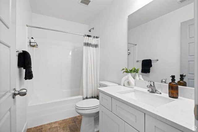 13077 S Keegan Dr, Herriman, UT 84096 - bathroom with vanity, toilet, shower / bath combo with shower curtain, stone finish flooring, and visible vents