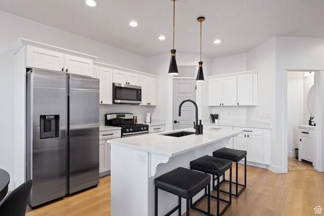 13077 S Keegan Dr, Herriman, UT 84096 - kitchen with light countertops, stainless steel appliances, white cabinetry, and a sink