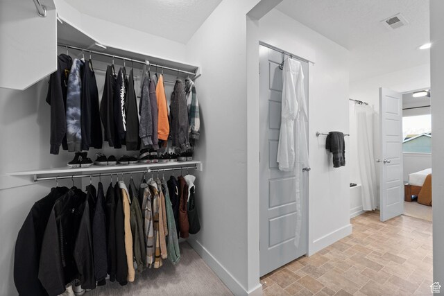 13077 S Keegan Dr, Herriman, UT 84096 - walk in closet with stone finish flooring and visible vents