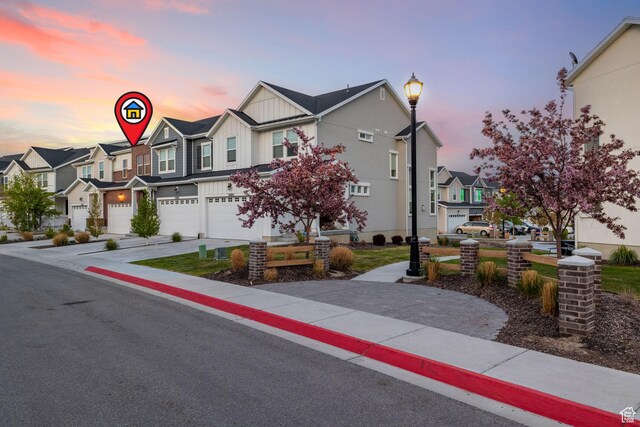 13077 S Keegan Dr, Herriman, UT 84096 - multi unit property featuring an attached garage, board and batten siding, driveway, and a residential view