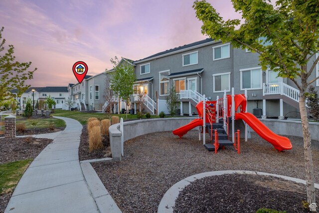 13077 S Keegan Dr, Herriman, UT 84096 - playground at dusk with a residential view and playground community